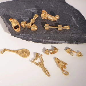 Detailed view of golden sports pendants featuring football boots, boxing gloves, and dumbbells