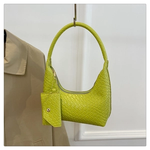 Detail of lime green woven handbag with matching coin purse and metallic zipper closure