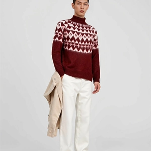 Detail of burgundy turtleneck sweater with white snowflake jacquard patterns
