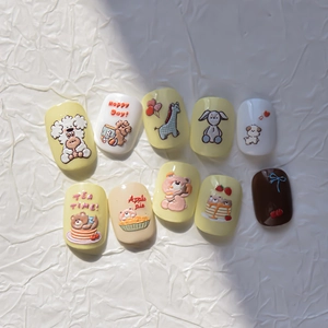 Close-up of embossed cartoon puppy and bear nail stickers with cream yellow 3D dessert patterns