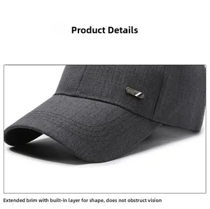 Detail of dark gray textured baseball cap featuring a metal logo and reinforced stitching
