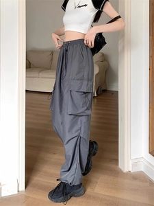 Detailed view of grey cargo pants with large side pockets and durable workwear fabric