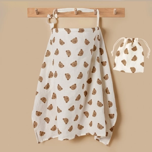 Detail of soft cotton muslin breastfeeding cover and storage bag with bear print