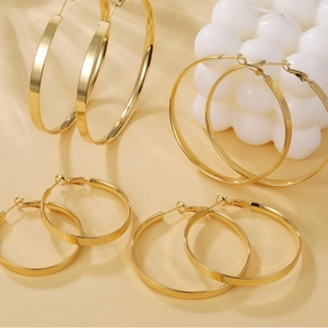 Set of gold-plated brass hoop earrings in various sizes with high-polish finish