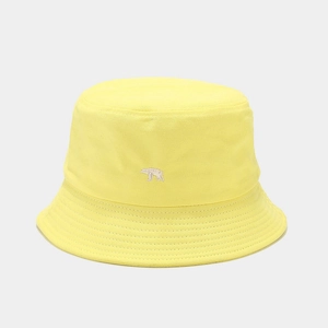 Detailed close-up of a yellow canvas bucket hat featuring white polar bear embroidery