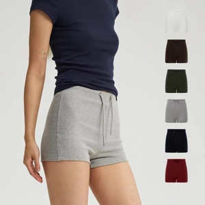 Detail of high waist ribbed knit sports shorts in various colors with drawstring