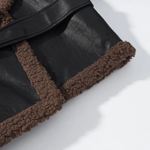 Detailed close-up of black faux leather and brown shearling lining on the sleeve cuff