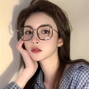 Retro oversized blue light blocking glasses with black and gold frame on model