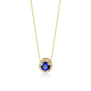 Macro shot of gold S925 silver necklace with round blue gemstone and halo stones