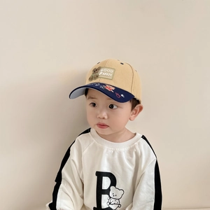 Close-up of baby baseball cap with bear patch and contrasting blue brim for toddlers