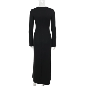 Detail of slim fit long sleeve black dress showing the elegant back and flowing floor length hem
