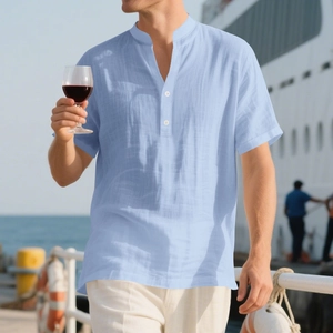 Detail of light blue linen shirt featuring a grandad collar and white buttons