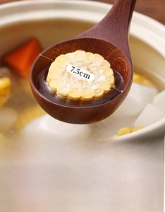 Detail of ebony wood ladle with 7.5cm wide head used in soup cooking scene