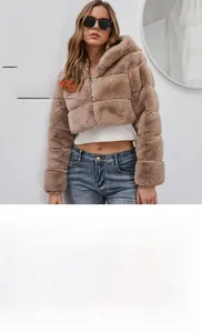 Macro view of thick brown faux fur texture and zipper detail on hooded winter jacket