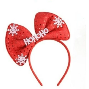 Detail of red Christmas headband with sequined bow and HOHOHO holiday letters