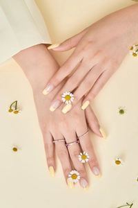 Detailed view of three stacked S925 silver rainbow zircon rings on a model's hand