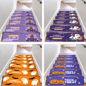 Close-up of Halloween anti-slip stair mats with pumpkin and ghost patterns on wood steps