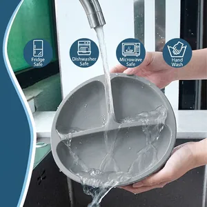 Silicone baby suction plate being rinsed under water to show easy cleaning feature