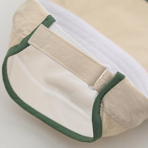 Detail of adjustable velcro strap and breathable mesh on children's sun hat