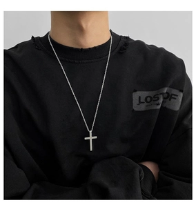 Polished titanium steel cross pendant necklace worn on a model with a trendy hip-hop style