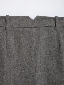 Detailed macro view of gray linen blend trousers showing waistband and belt loops texture