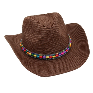 Detail of colorful bohemian beads on a coffee brown woven straw cowboy sun hat