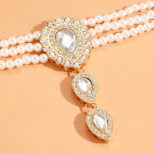 Detailed close-up of a vintage French pearl necklace with a rhinestone crystal pendant