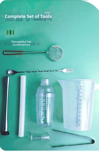 Flat lay of a 700ml cocktail shaker set with stainless steel bar tools on green background