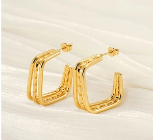 Detailed macro view of triple-layered gold-plated geometric square stud earrings for women