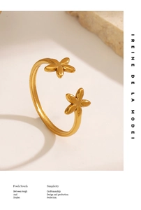 Detailed close-up of 18K gold plated stainless steel open ring with floral design