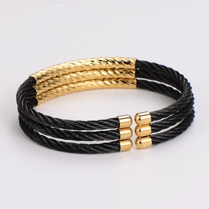 Three-layer black braided steel wire open bangle with polished gold finish accents