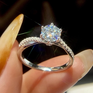 Detailed close-up of classic twisted band ring with sparkling round moissanite and micro-pavé diamonds