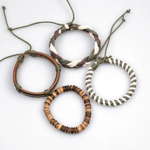 Detailed set of four handmade braided leather and wood bead bracelets in green and brown