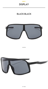 Macro details of black oversized cycling sunglasses showing front and side profile views