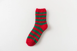 Close-up of thick coral fleece Christmas socks featuring red and green winter stripes