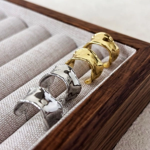 Minimalistische C-förmige Lava-Ringe in Gold und Silber mit unregelmäßigem Wellenmuster