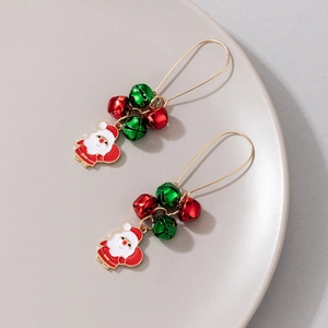 Detail of Christmas earrings with Santa Claus charms and red green enamel bells