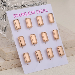 Twelve rose gold rectangle stainless steel stud earrings displayed on a white card