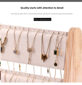 Detailed view of the multi-tier wooden necklace display stand with beige velvet lining