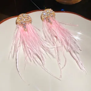 Sparkling pink feather tassel earrings with silver needle and rhinestones in gold setting