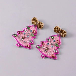 Detail of handmade beaded Christmas tree earrings with colorful rhinestones and gold bow