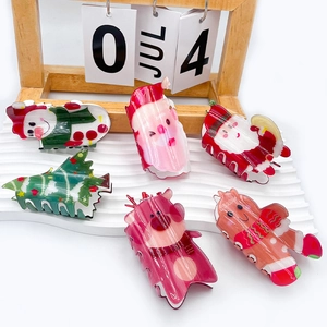 Christmas acrylic hair claws featuring reindeer, gingerbread man, and Santa Claus motifs