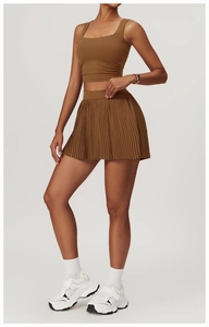 Detailed full-body view of coffee brown sports vest and pleated tennis skirt set for women