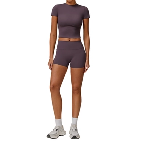 Women's dark purple two-piece yoga set featuring cropped short sleeve top and high waist shorts