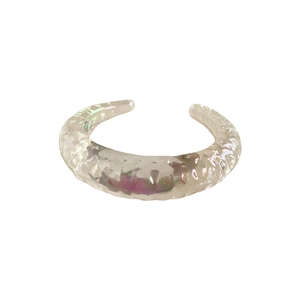 Irregular geometric bangle with iridescent finish and minimalist fluid texture design