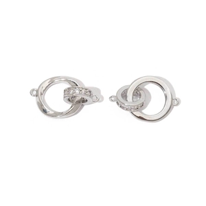 Detail view of two silver interlocking jewelry connector loops with pavé zircon stones