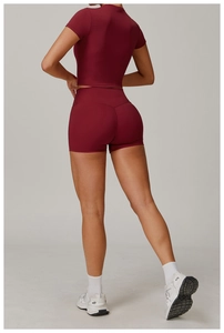 Rear view of deep red high-waist yoga set with slim fit top and lifting sports shorts