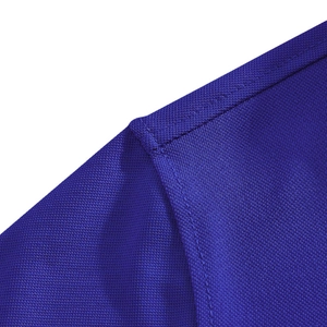 Close-up of navy blue polo shirt fabric with breathable mesh texture and neat stitching