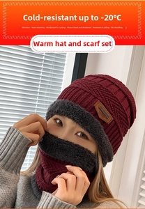 Detail of burgundy knit beanie set with warm grey faux fur lining and leather patch