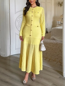 Elegant yellow textured long-sleeve maxi dress with gold buttons and pleated skirt